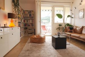 a living room with a couch and a table at Stylish hideout - mountain view in Brixen