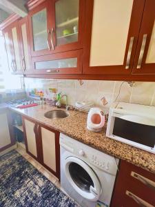 a kitchen with a washing machine and a sink at A cozy room in Istanbul