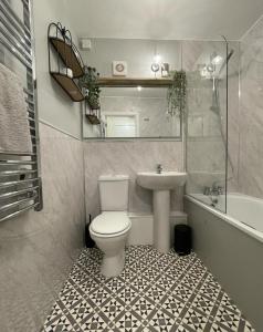 a bathroom with a toilet and a sink at Seaways Apartment in Worthing