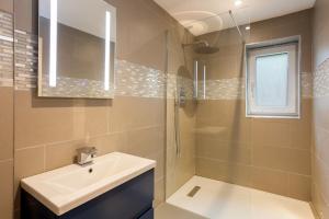 a bathroom with a sink and a shower at Millside in Stroud