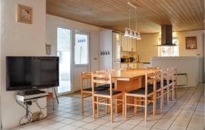comedor con mesa y TV en 5 Bedroom Gorgeous Home In Ringkbing en Ringkøbing