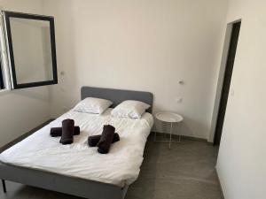 a bedroom with a bed with two pillows on it at Maison moderne in Is-sur-Tille