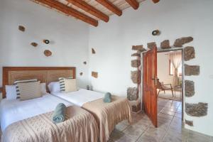 a bedroom with a large bed in a room at Casa Rural Nel in Tinajo +46 photos