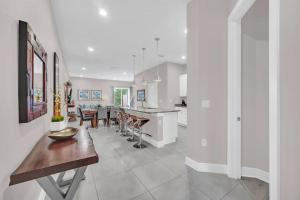 a kitchen and living room with a table and a dining room at Magical Residence Resort, 5 min Disney in Orlando