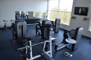 a gym with several treadmills and exercise bikes at Hotel Reima Country Center in Jämijärvi