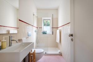a bathroom with a sink and a toilet at Bombarda Homes in Porto +267 photos
