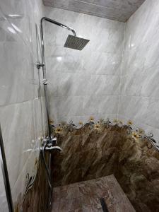 a shower with a glass door in a bathroom at Deluxe Spacious Apartment with 1 bedroom , New building, Near City Center in Yerevan +15 photos