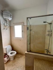 a bathroom with a toilet and a glass shower at GS 23 in Hurghada