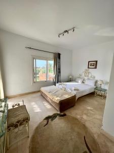 a large white room with a bed and a window at GS 23 in Hurghada
