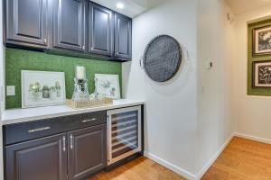 a kitchen with dark cabinets and a counter top at Day Trip to Dtwn Phoenix Peoria Retreat with Pool in Peoria +22 photos