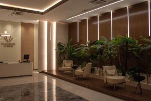 a lobby with chairs and plants in a building at DIAMOND OF SKOPJE JB in Skopje