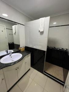 a bathroom with a sink and a large mirror at COSTA AZUL APARTMENTS - 2B in Puerto de Mogán