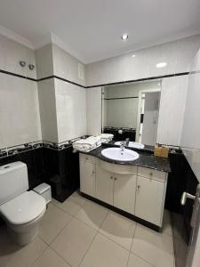 a bathroom with a toilet and a sink at COSTA AZUL APARTMENTS - 2B in Puerto de Mogán