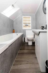a bathroom with a sink and a tub and a toilet at Stunning House near Fort William - Taigh Sona in Spean Bridge