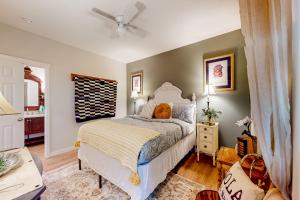 a bedroom with a bed and a ceiling fan at NOLA on Main in Eureka Springs