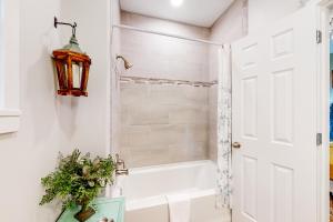 a bathroom with a white tub and a shower stall at NOLA on Main in Eureka Springs
