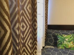 Una habitación con una cortina con estampado de cebra y un sofá. en Condo , WIFI up to 100mbps , Infinity Pool, en Cebú