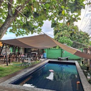 a swimming pool with a tent over it at Gengmengyuan B&B in Xikou