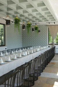 a long table in a room with chairs at Parvana Hotel in Gyumri
