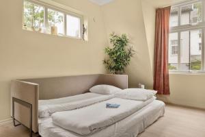Llit o llits en una habitació de Dinbnb Apartments I New 2021 I SONOS and SMART TV