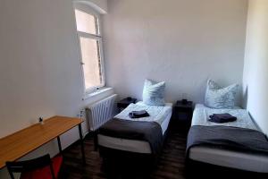 mały pokój z 2 łóżkami i oknem w obiekcie Apartment ROTER FADEN w Hanowerze