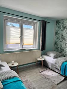 a bedroom with two beds and a window at Ferienhaus Herztor in Bad Bibra