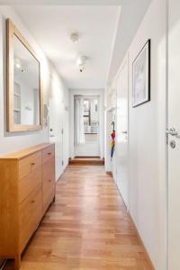 a hallway of a home with a wooden floor at Dinbnb Apartments I Cozy 1-Bedroom Nestled in the Heart of Bergen in Bergen