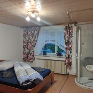 a bedroom with a bed and a window at Ferienwohnung Patrycja in Weissenbach am Lech