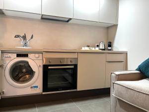 a kitchen with a washer and a dishwasher at Ca'Sazen Trilo 19 in Brescia