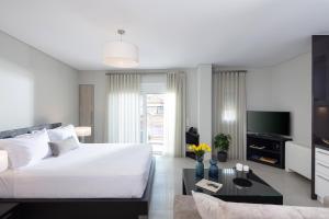 a bedroom with a large bed and a tv at Piccadilly House in Arta