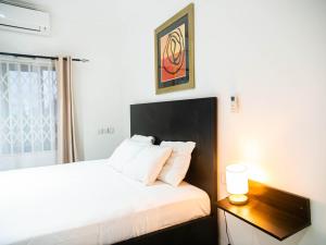 Posteľ alebo postele v izbe v ubytovaní KoKo Palm Inn