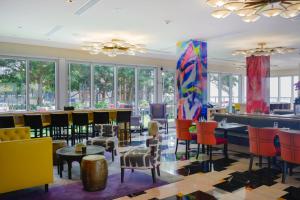 a lobby with colorful chairs and tables and windows at Luxury 45th Floor Suite at Icon in Miami