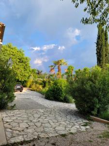 a stone driveway with a car driving down it at Studio lit double. in Gréoux-les-Bains