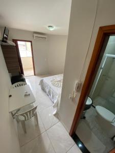 a bedroom with a bed and a sink and a toilet at Chesmar Plaza Hotel in Vera Cruz de Itaparica