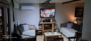 a living room with a couch and a table at Zoe garden home in Spata +179 photos