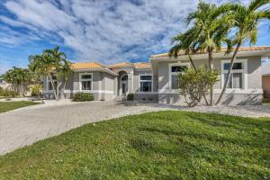 a large house with palm trees in front of it at 228 Freeport in Punta Gorda