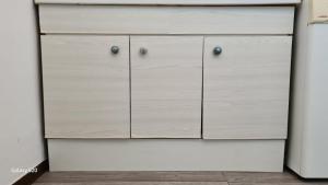 a white cabinet with two doors in a room at L'angolo di Roby in Termoli