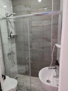 a bathroom with a shower and a toilet and a sink at The Professor's Hotel in Bodrum City
