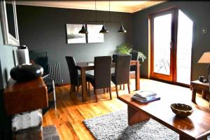 a living room with a dining room table and chairs at Water view Apartment in Belfast