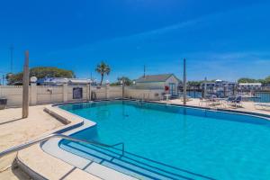 a large swimming pool with blue water at Inn at Camachee Harbor Garden View 15 in Saint Augustine