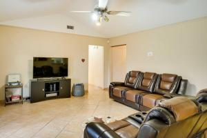 a living room with two leather couches and a flat screen tv at San Antonio Home Near Nature, Parks and Trails in San Antonio