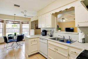 a kitchen with a sink and a table with chairs at San Antonio Home Near Nature, Parks and Trails in San Antonio