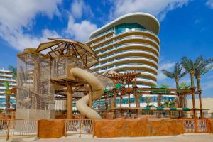 a water park with a slide in front of a building at Waldorf Astoria Lusail, Doha in Doha
