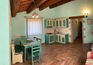 a kitchen with a table and a dining room at Borgo Di Fonni in Sellano