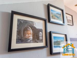 a group of framed pictures hanging on a wall at 2BR Home In Barrow-in-Furness Sleeps 8 close to BAE Systems, Hospital, Lakes in Barrow in Furness