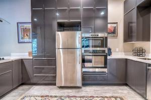 a kitchen with a stainless steel refrigerator and stove at The Chic Cabin Apartment in Flagstaff