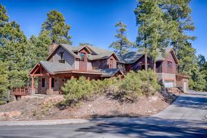 a house on a hill with a driveway at The Chic Cabin Apartment in Flagstaff