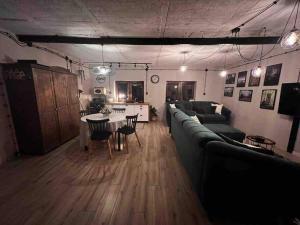 a living room with a couch and a table at Apartament w ,chlewiku” in Gołdap +12 photos