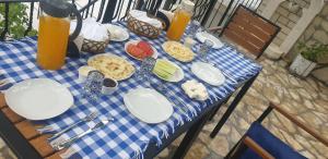 a blue and white table with food and drinks on it at Hazmurat Hotel in Gjirokastër