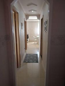 a hallway leading to a living room with a table at soleil d'chamalo in Fnidek